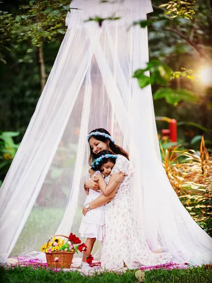 A tender moment between a mother and her daughter during an outdoor portrait session. The soft light and gentle embrace create a dreamy, emotional photograph that families will treasure forever.