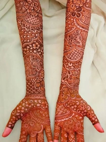 This is the beautiful reddish brown color of a fresh henna stain, about 24 hours after the paste was removed. The design is clear and the color is even across both arms, showing the quality of the organic henna.