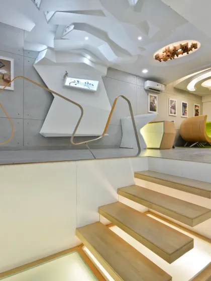 Cantilevered wooden stairs, illuminated from below, provide access to the lower level of my studio. This design detail enhances the feeling of openness and spatial continuity between the two floors.