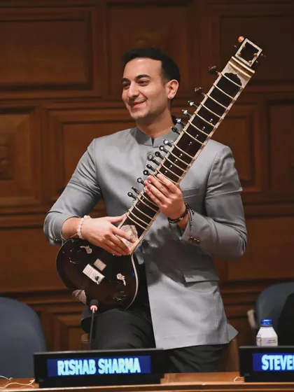 A proud moment, holding my sitar at the United Nations panel. Being invited as a youth leader to advocate for mental health through traditional Indian music was a true honor.