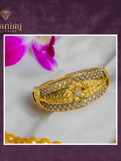 This handcrafted gold kada is as unique as the person who wears it. The intricate floral and leaf engraving is surrounded by rows of sparkling diamonds.