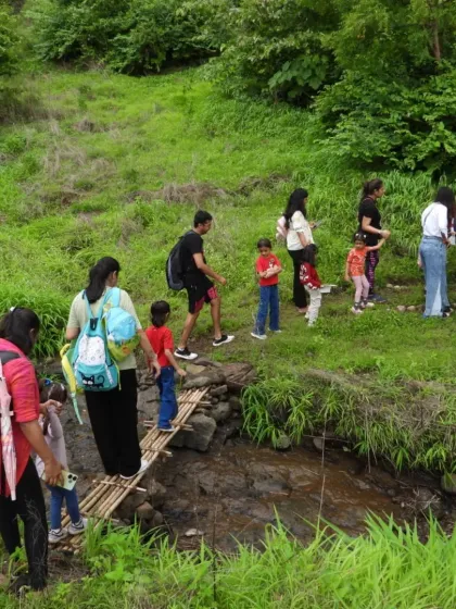 Adventure is a family affair. On our guided nature trails, families navigate paths together, crossing makeshift bridges and exploring lush greenery, turning a simple walk into a shared journey of discovery and teamwork.