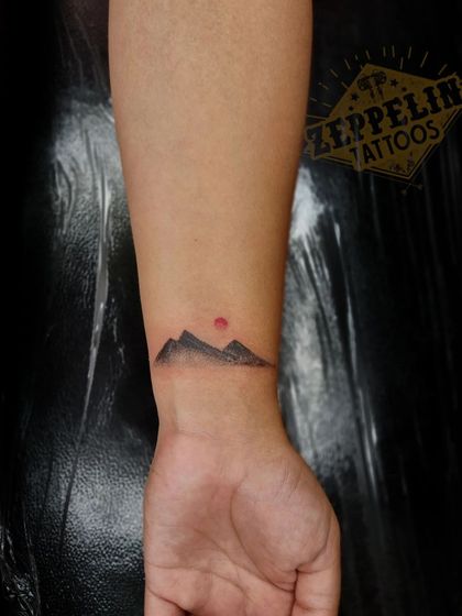 A closer look at the minimalist mountain tattoo used for scar concealment on the wrist.