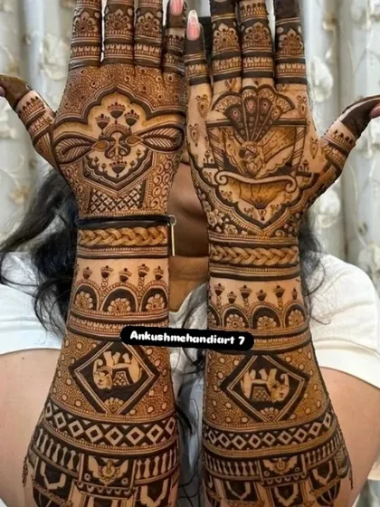 This design features personalized initials inside diamond-shaped frames on the arms, with the palms covered in traditional floral and geometric patterns.