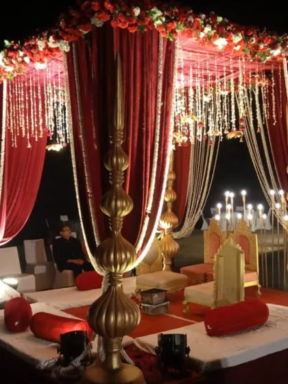 For a classic royal wedding look, this traditional red and gold mandap is perfect. The deep red drapes, golden pillars, and intricate details create a timeless and regal setting.