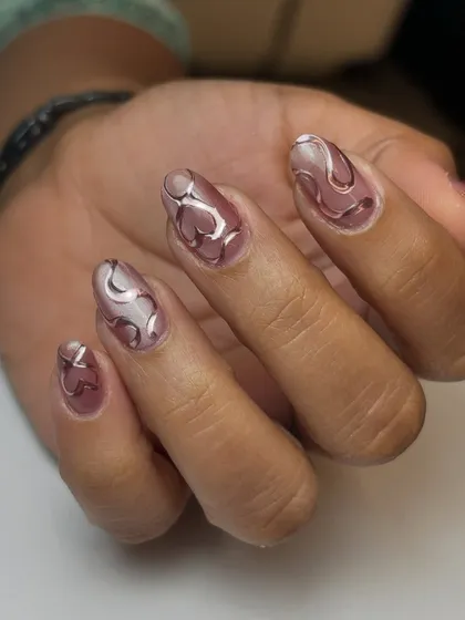 The full set of the chrome hearts and swirls design, showing how the abstract patterns work together across the nails.