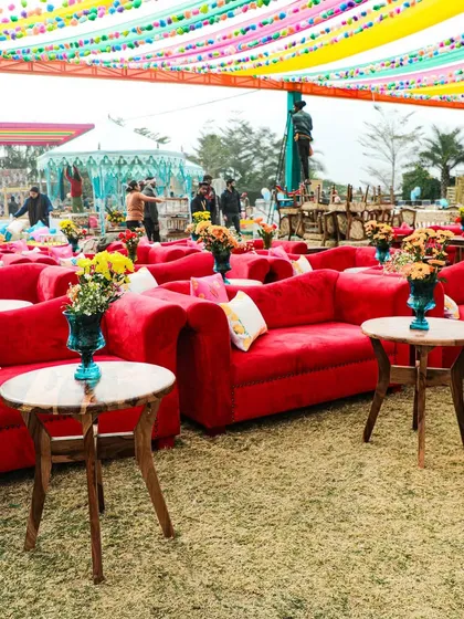 Comfortable and vibrant seating at the spice-themed Mehendi. The bright red sofas and colorful drapes created a festive and welcoming atmosphere for guests.