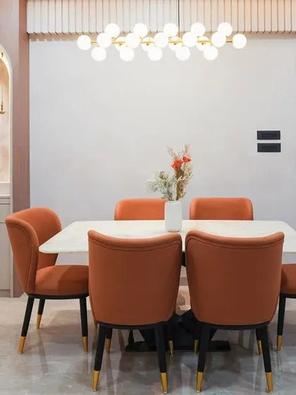This modern classic dining space seamlessly integrates a custom-designed pooja unit within an arched niche. We believe in creating designs that honor your traditions while fitting perfectly within a contemporary home, blending spiritual corners with everyday elegance.