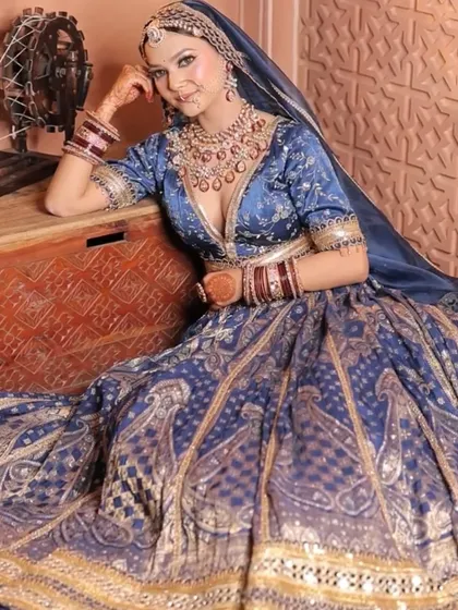 Three shots of a model in a royal blue Banarasi lehenga. These images showcase the outfit's rich texture and how it can be styled for a majestic, traditional photoshoot.