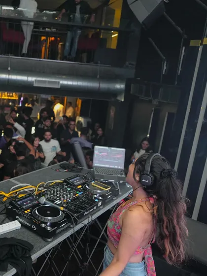 An over-the-shoulder view of my workspace during a busy night. You can see the multi-level club is full, with people enjoying the music from the floor to the balcony.