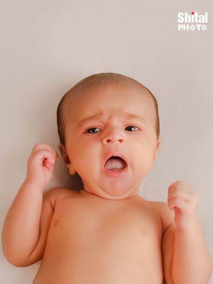 Capturing a big yawn. These fleeting, real-life moments are just as important as the perfect smile, telling the story of your baby's first days.