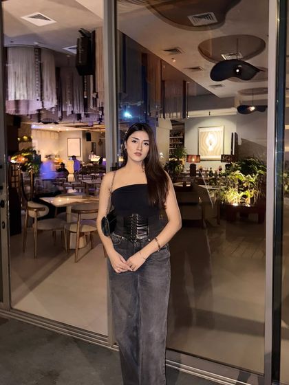 Another full-length shot, capturing the chic restaurant background.