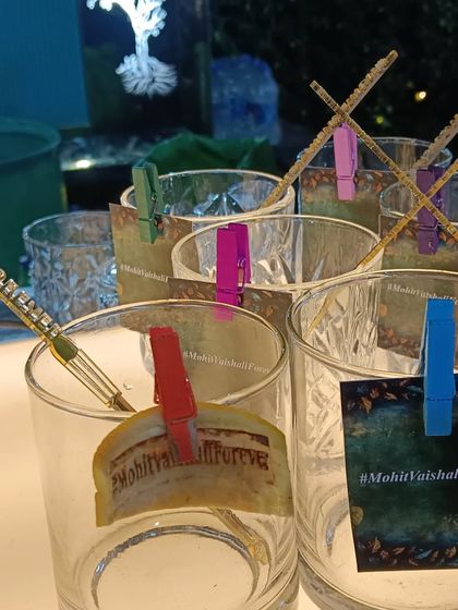 We can create custom glass tags with your wedding hashtag, like '#MohitVaishaliForever', so guests never lose their drink and have a fun keepsake.