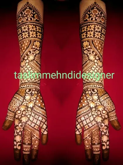 This elaborate bridal design is perfect for the bride who wants maximum coverage. The pattern is dense with floral and geometric work, creating a stunning sleeve of henna from the fingers to the elbow.