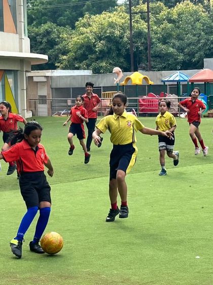 A student skillfully dribbles the ball during an intense match in our Inter-House Football Tournament. We encourage healthy competition and provide opportunities for students to develop their football skills on our professional-grade artificial turf.