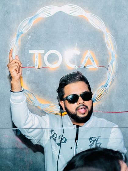 Glimpses of a Saturday night extravaganza at Toca Koramangala. I'm pointing to the sky, signaling the start of a great party.