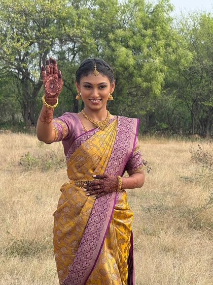 A happy, waving shot of Priyanka. Her makeup enhances her natural beauty, and her smile shows her excitement for the new journey ahead.