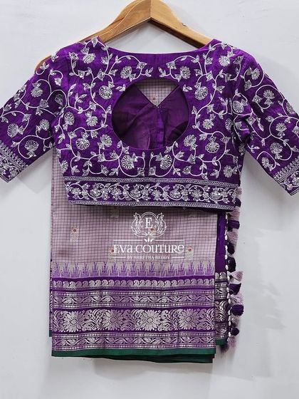 The back of the silver embroidered blouse, featuring a stylish keyhole opening.