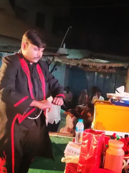 Setting up for a trick during a night show. The magic continues even after the sun goes down, creating a different and mysterious atmosphere.