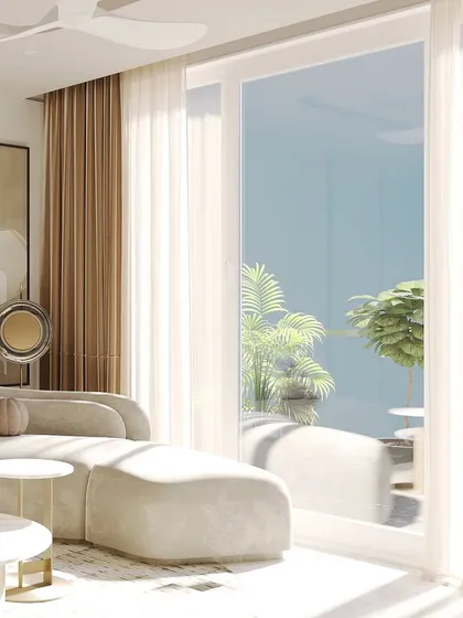 The connection to the outdoors is essential. Here, a large sliding glass door opens to a terrace, blurring the lines between inside and out and filling the serene living space with natural light.