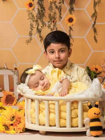 A sweet "bee and sunflower" themed shoot for a brother and his newborn sister. This bright and cheerful setup is perfect for celebrating a new arrival.