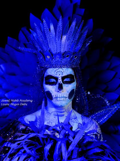 A full view of the elaborate sugar skull makeup, complete with a feathered headpiece. This shows how we guide students in creating a complete, impactful character look.