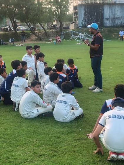 The players listen intently during a strategy session on the field. Understanding the game's mental side is crucial for success.