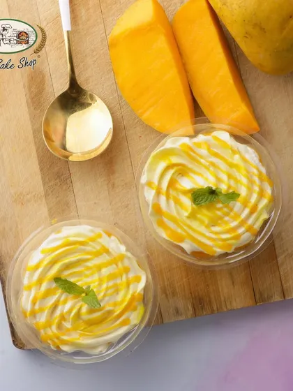 An overhead shot of our creamy Mango Mousse cups, garnished with fresh mint.