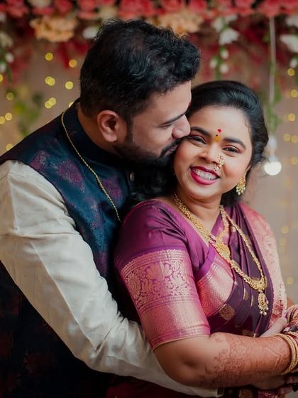 Capturing the warmth and happiness of an engagement celebration. This couple shares a loving embrace against a backdrop of festive lights, perfectly showcasing the joy of the occasion.