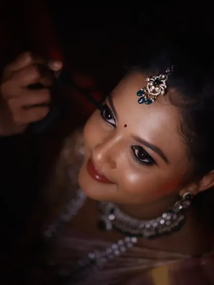 A close-up of the magic. This shot highlights the detailed eye makeup and the dewy, glossy skin finish I aim for. My goal is to make your features pop without feeling heavy, ensuring you look perfect both in person and on camera.