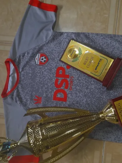 A winner's trophy and a 'Best Coach' award. We develop champion players and are led by the best.