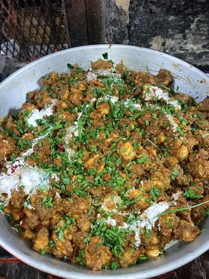 Look at the color and texture on this chicken dish. It's finished with fresh cream and coriander, ready to be served hot. This is the quality I bring to every single dish.