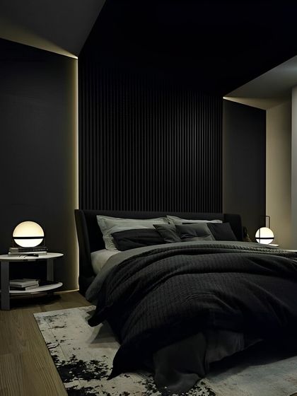 A bold, all-black bedroom design for a sophisticated and modern look. The vertical fluted paneling behind the bed adds texture, while soft, warm lighting creates an intimate and cozy ambiance.