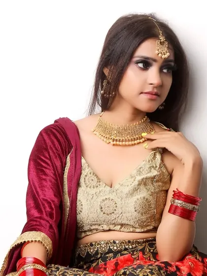 A model styled in bridal attire, featuring heavy gold jewelry and a traditional lehenga. This is an example of a look test or portfolio shoot for the bridal market.