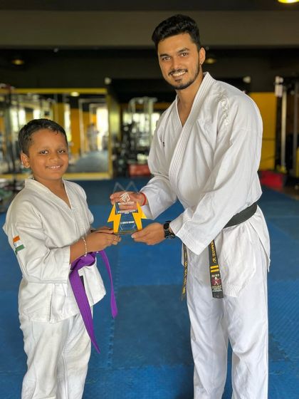 Presenting the "Best Student of the Year" award. This recognizes not just skill, but also discipline, respect, and consistent effort.