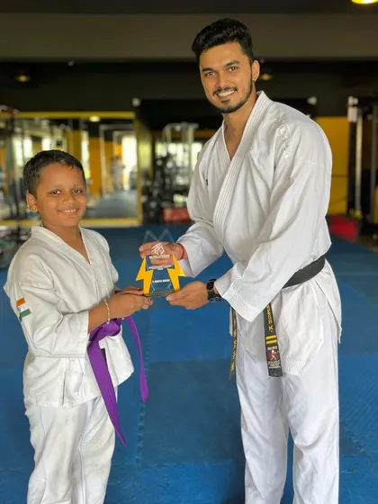 Presenting the "Best Student of the Year" award. This recognizes not just skill, but also discipline, respect, and consistent effort.
