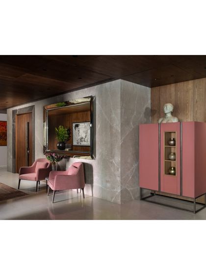 A pop of color in the Camellias lobby with a pink cabinet. This piece stands against a leather-finished marble wall, showcasing my love for mixing unexpected elements and sculptural forms.