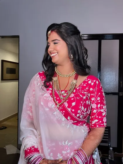 A candid moment from her reception night. The makeup is designed to look fresh and radiant, even after hours of celebration.