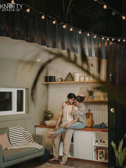 The warm glow of string lights adds a cozy and magical feel to this indoor pre-wedding portrait. It’s all about creating the right atmosphere for romance.