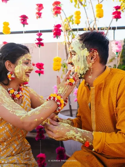 The Haldi ceremony is all about joy and vibrant color. We designed a beautiful floral curtain backdrop that made this couple's playful and happy moments even more memorable.