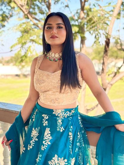 A portrait shot showcasing the details of my blue embroidered lehenga and statement jewelry. I love creating a complete look that complements the event's decor and theme.