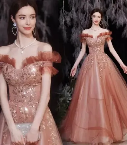 Make an entrance at your next big event with a gown that is sure to turn heads. This off-shoulder cocktail dress features intricate sequin work and a unique rust color, making it a standout choice for parties, receptions, and special occasions.