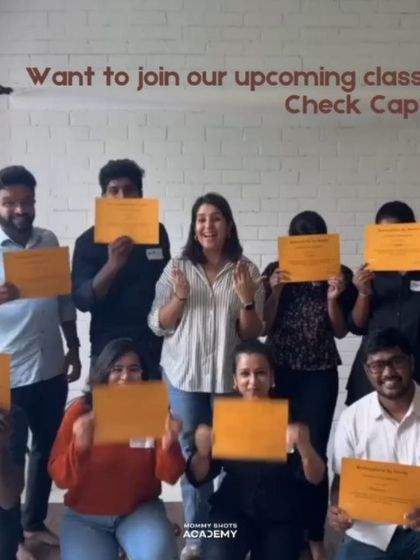 A candid shot of students celebrating with their certificates after a workshop.