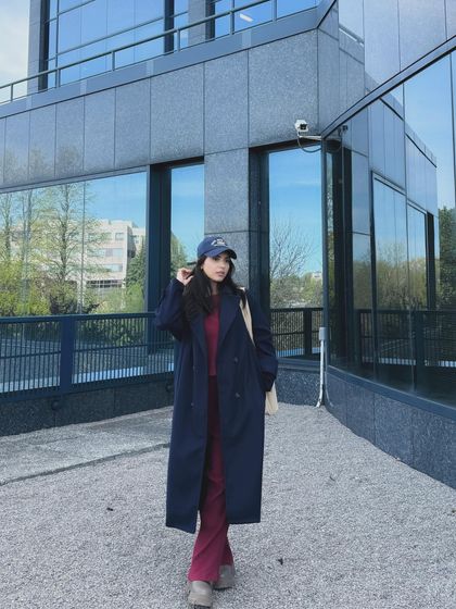 A final shot of the series, showing a confident pose against the modern architecture.