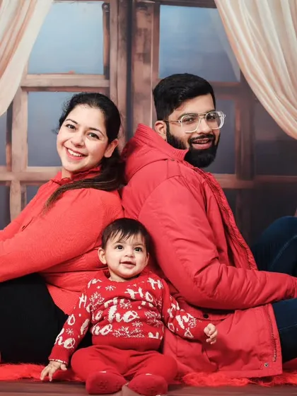 A classic family pose from a Christmas-themed shoot, with everyone dressed in festive red.