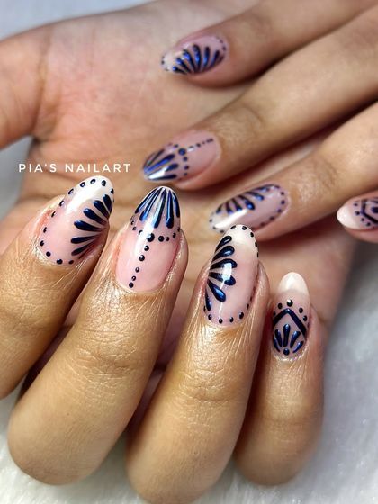 Intricate chrome art on a nude base. This design uses a deep blue chrome to create detailed, artistic patterns.