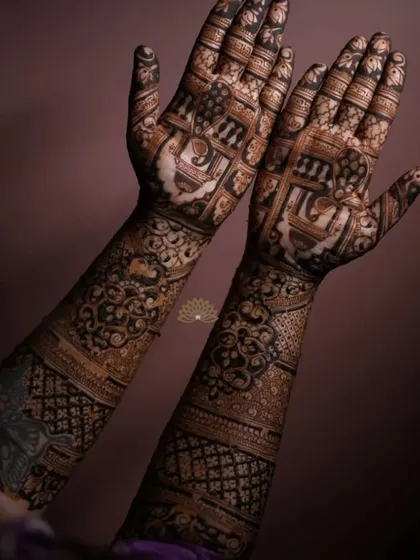 An artistic shot of a full engagement mehndi, showing the intricate details of the elephant figures and traditional patterns.