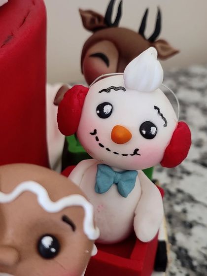 A snowman with a blue bow tie, ready for the festive ride.