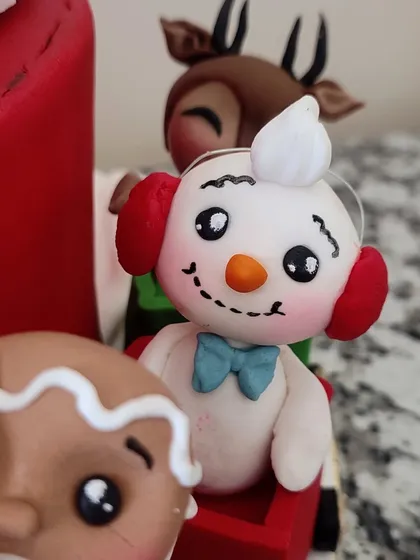 A snowman with a blue bow tie, ready for the festive ride.