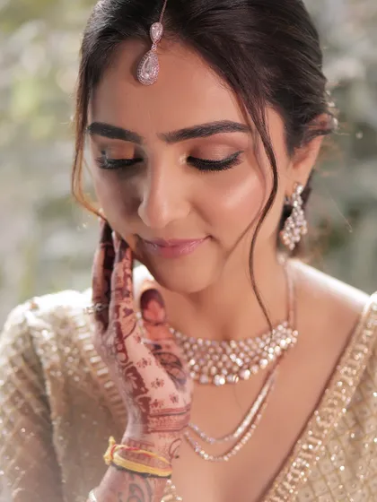 A close-up of the bride's soft and minimal makeup, paired with a gentle updo. This look is perfect for the bride who wants to feel like herself, only elevated.